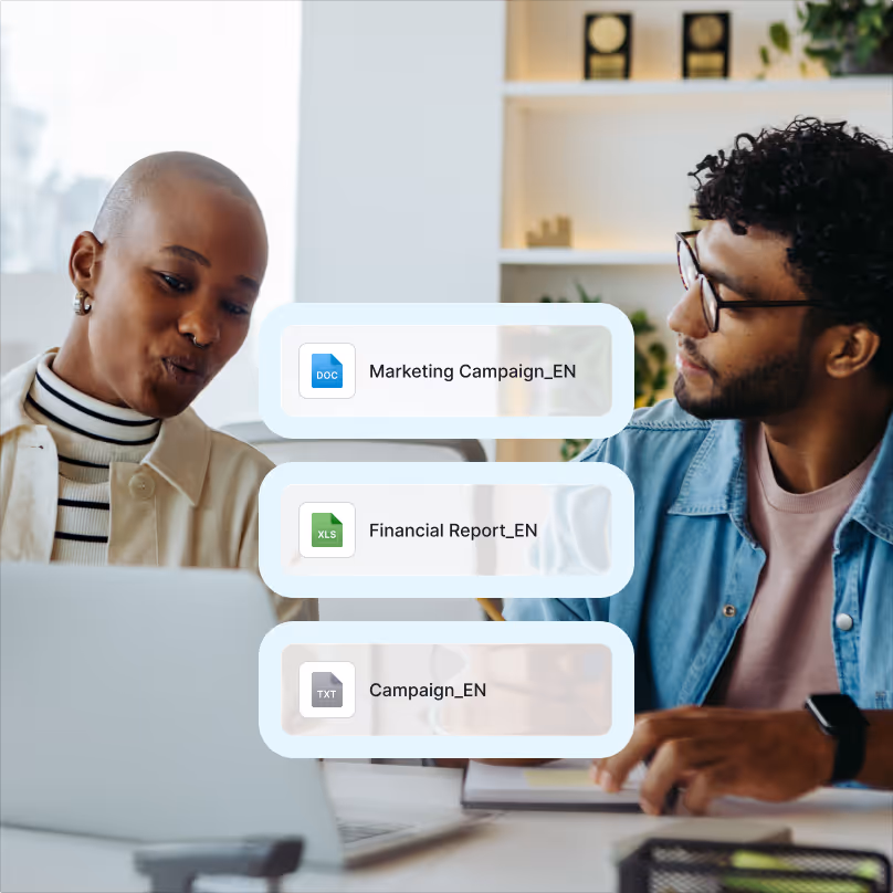 Two colleagues discussing work at a desk with floating icons of document files labeled Marketing Campaign_EN, Financial Report_EN, and Campaign_EN.